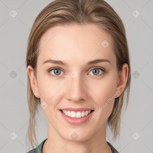 Joyful white young-adult female with medium  brown hair and blue eyes