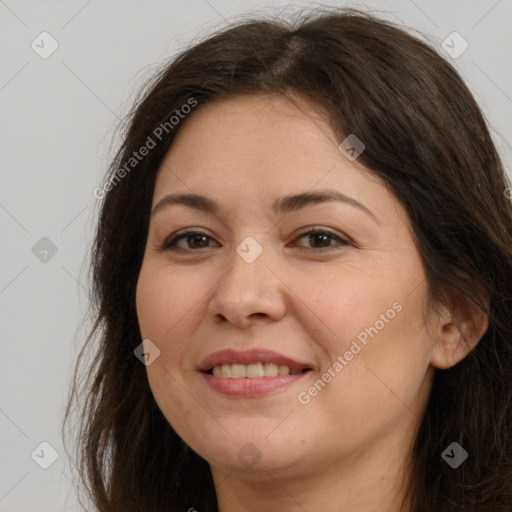 Joyful white adult female with long  brown hair and brown eyes