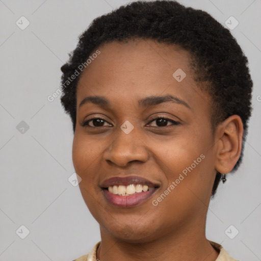 Joyful black young-adult female with short  brown hair and brown eyes