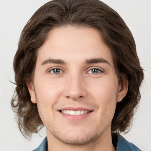 Joyful white young-adult male with medium  brown hair and brown eyes