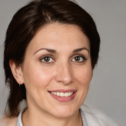 Joyful white adult female with medium  brown hair and brown eyes