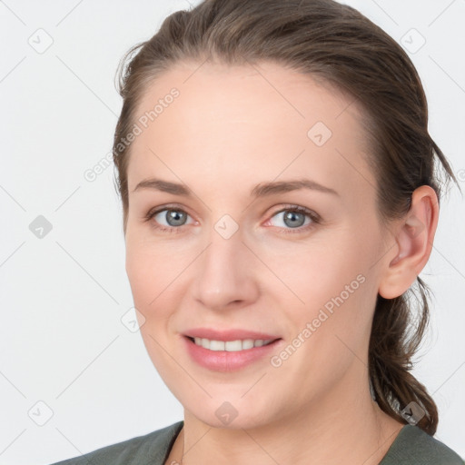 Joyful white young-adult female with medium  brown hair and grey eyes