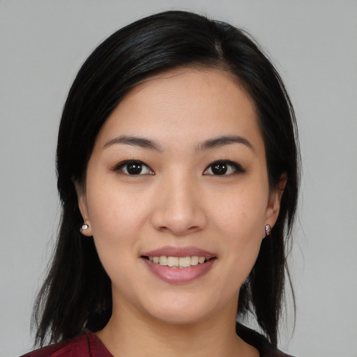 Joyful asian young-adult female with medium  black hair and brown eyes