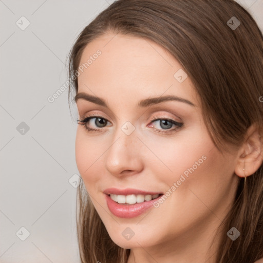 Joyful white young-adult female with long  brown hair and grey eyes