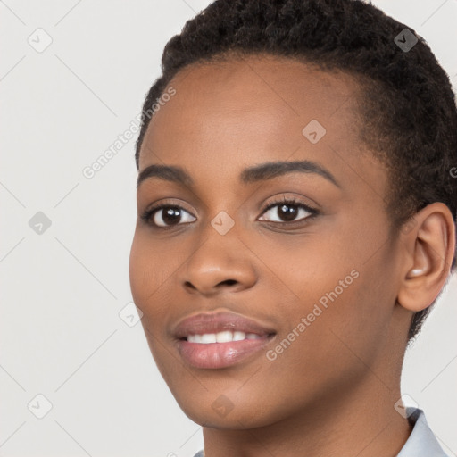 Joyful black young-adult female with short  brown hair and brown eyes