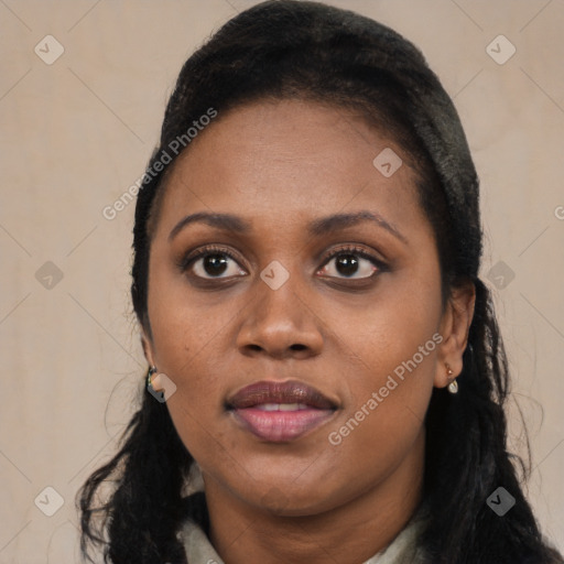 Joyful black young-adult female with long  black hair and brown eyes