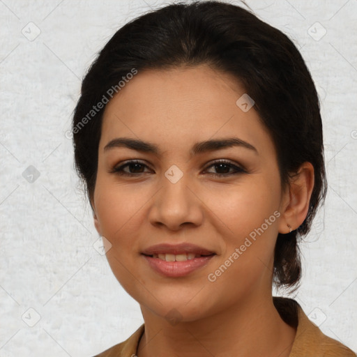 Joyful latino young-adult female with medium  brown hair and brown eyes