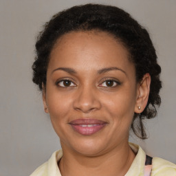 Joyful black adult female with medium  brown hair and brown eyes