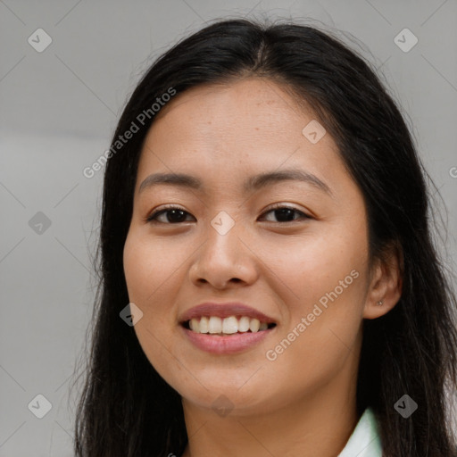 Joyful asian young-adult female with long  brown hair and brown eyes