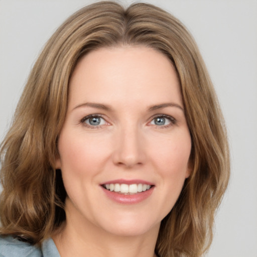 Joyful white young-adult female with medium  brown hair and green eyes