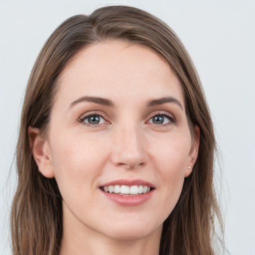 Joyful white young-adult female with long  brown hair and grey eyes