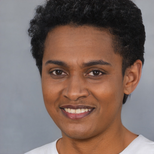 Joyful black young-adult female with short  black hair and brown eyes