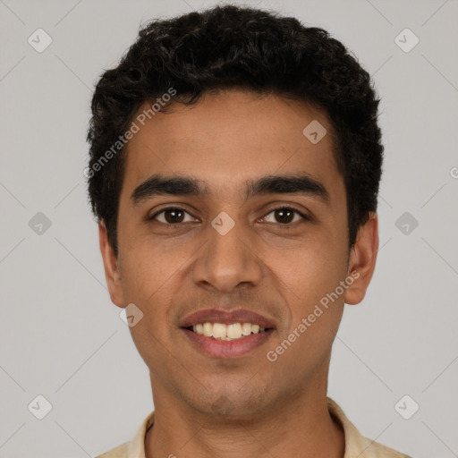 Joyful latino young-adult male with short  black hair and brown eyes