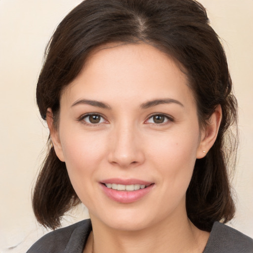 Joyful white young-adult female with medium  brown hair and brown eyes