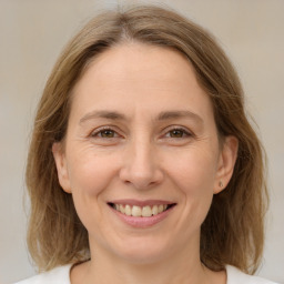 Joyful white adult female with medium  brown hair and brown eyes