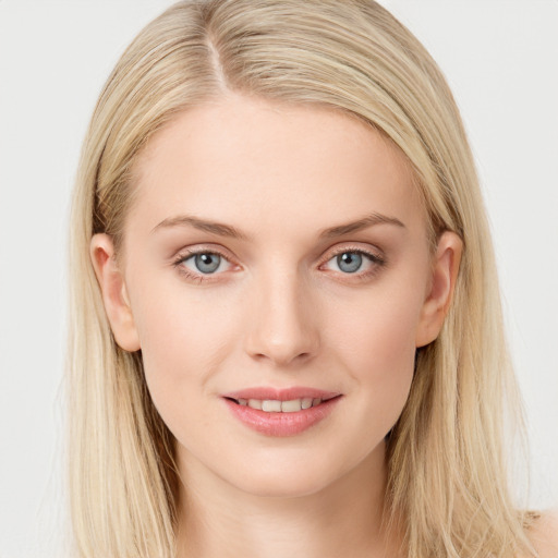 Joyful white young-adult female with long  brown hair and blue eyes