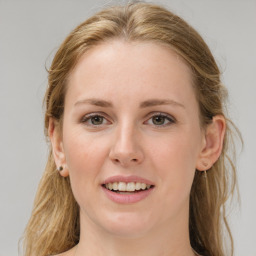 Joyful white young-adult female with long  brown hair and blue eyes