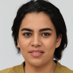 Joyful latino young-adult female with medium  brown hair and brown eyes