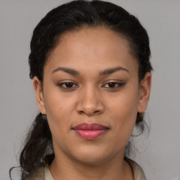 Joyful latino young-adult female with medium  brown hair and brown eyes