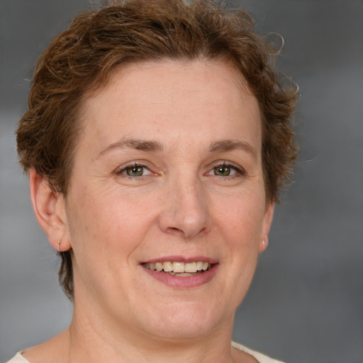 Joyful white adult female with short  brown hair and grey eyes