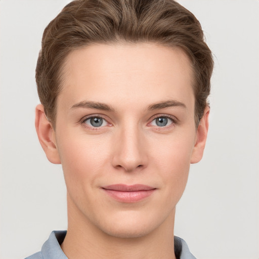 Joyful white young-adult female with short  brown hair and grey eyes