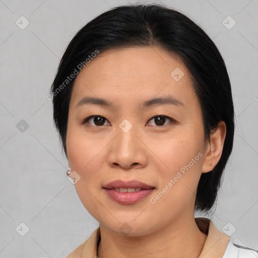 Joyful asian young-adult female with medium  black hair and brown eyes