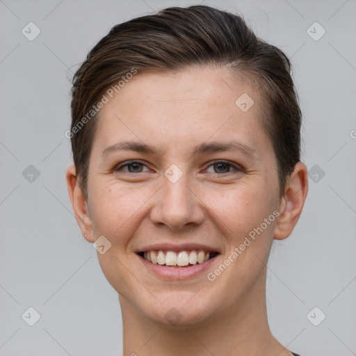 Joyful white young-adult female with short  brown hair and grey eyes