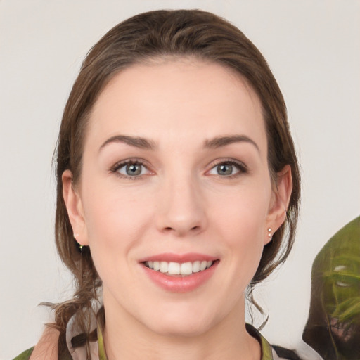 Joyful white young-adult female with medium  brown hair and grey eyes