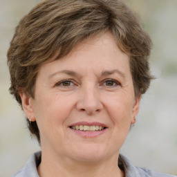 Joyful white adult female with medium  brown hair and grey eyes