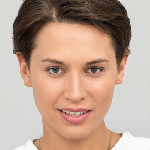 Joyful white young-adult female with short  brown hair and brown eyes