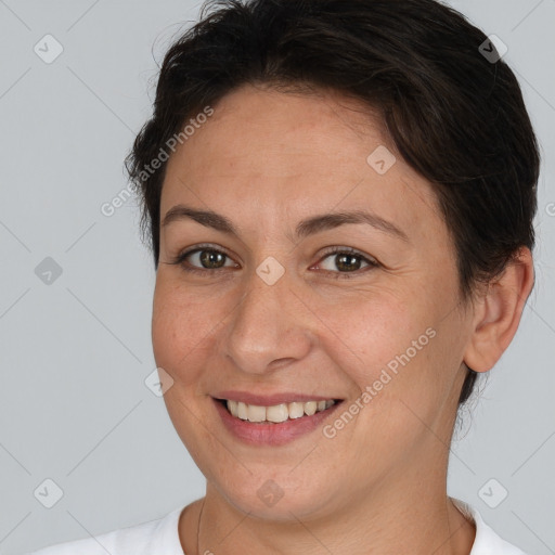 Joyful white adult female with short  brown hair and brown eyes