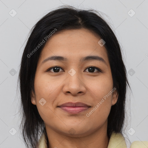 Joyful latino young-adult female with medium  brown hair and brown eyes