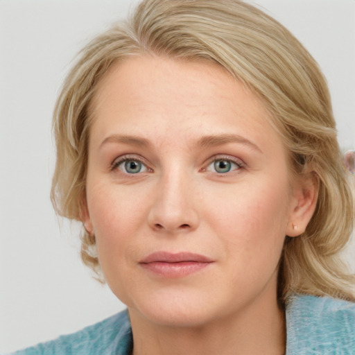 Joyful white young-adult female with medium  brown hair and blue eyes