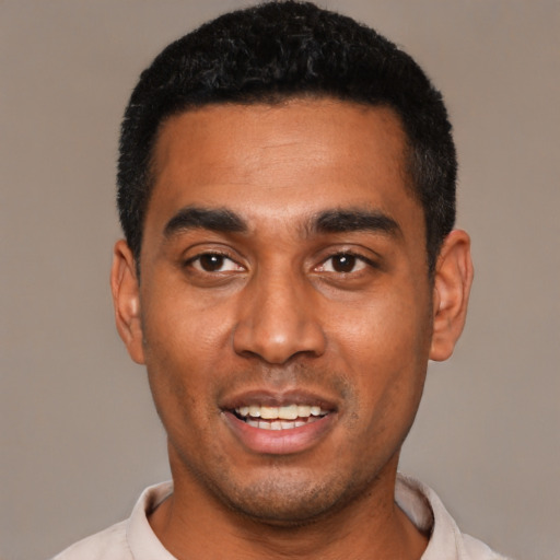 Joyful black young-adult male with short  black hair and brown eyes