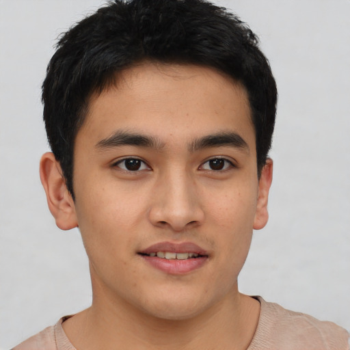 Joyful asian young-adult male with short  brown hair and brown eyes