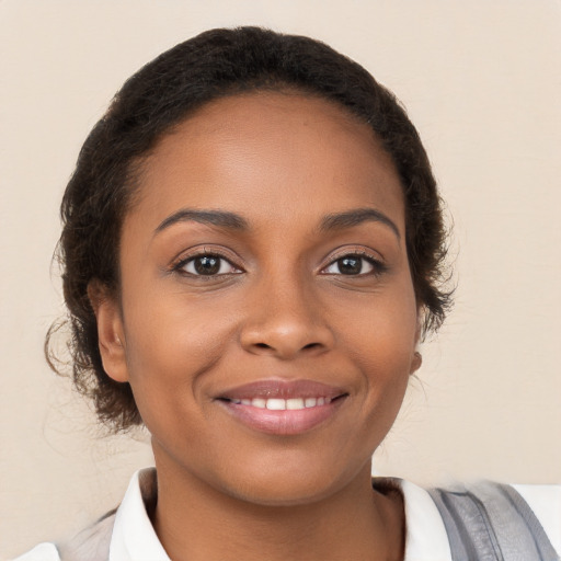 Joyful black young-adult female with medium  brown hair and brown eyes