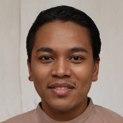 Joyful latino young-adult male with short  black hair and brown eyes