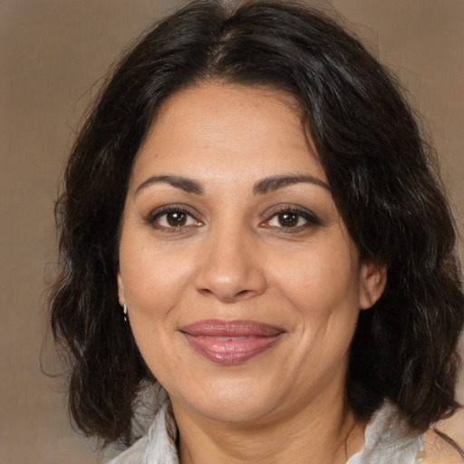 Joyful white adult female with medium  brown hair and brown eyes