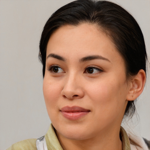 Joyful asian young-adult female with medium  brown hair and brown eyes