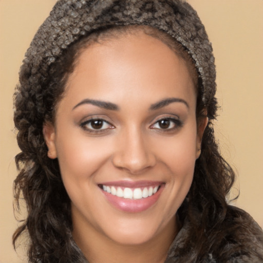 Joyful latino young-adult female with long  brown hair and brown eyes