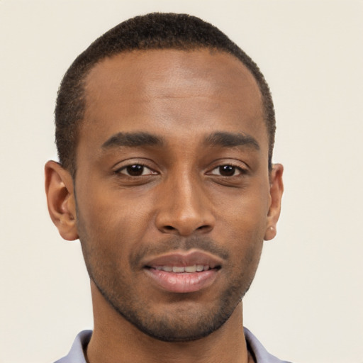 Joyful black young-adult male with short  brown hair and brown eyes