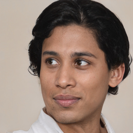 Joyful black young-adult male with short  brown hair and brown eyes