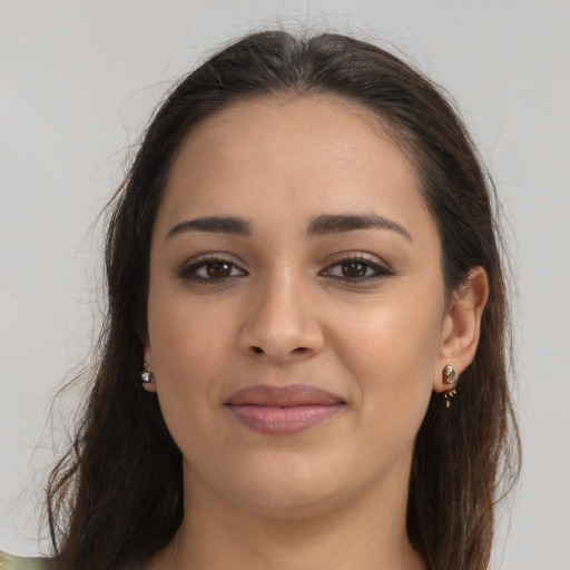 Joyful latino young-adult female with long  brown hair and brown eyes