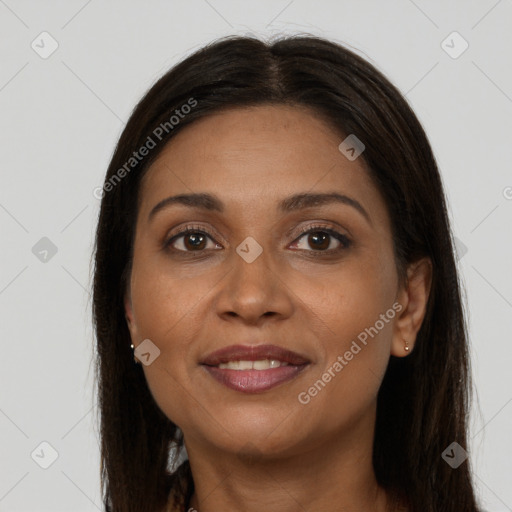 Joyful black adult female with long  brown hair and brown eyes