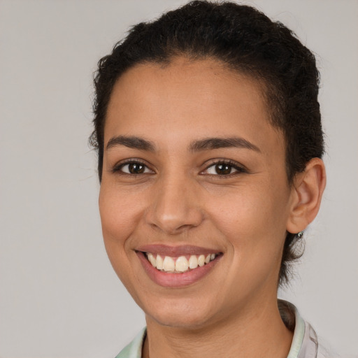 Joyful white young-adult female with short  brown hair and brown eyes