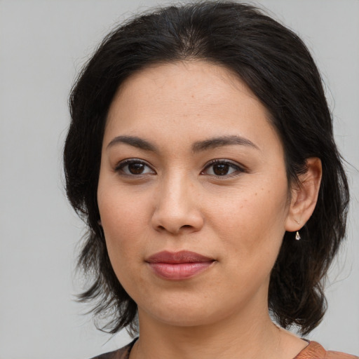 Joyful asian young-adult female with medium  brown hair and brown eyes