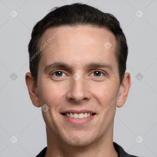 Joyful white young-adult male with short  black hair and brown eyes