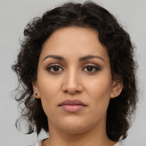 Joyful latino young-adult female with medium  brown hair and brown eyes