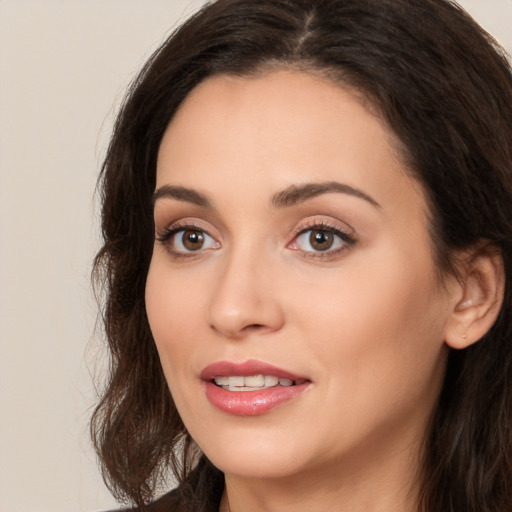 Joyful white young-adult female with long  brown hair and brown eyes