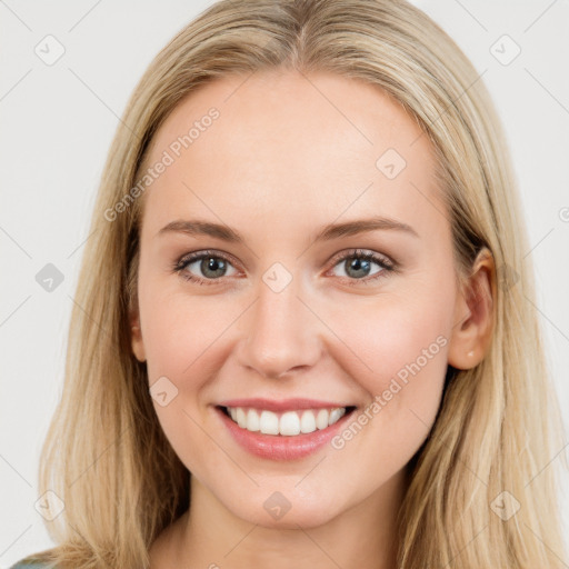 Joyful white young-adult female with long  brown hair and blue eyes